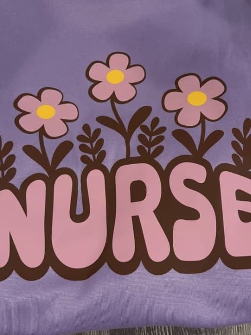 Gabbie's finished purple shirt with NURSE in retro letters