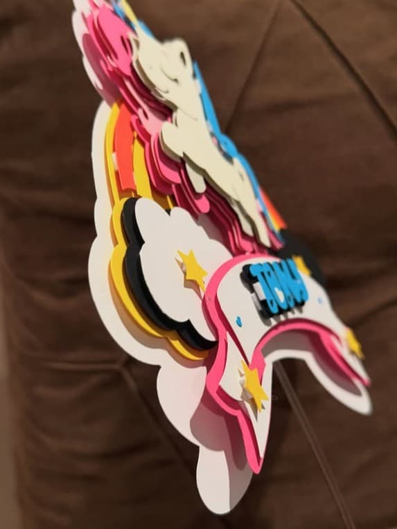Layered unicorn cake topper seen from the side